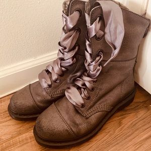 Grey Doc Martens with silver ribbon.